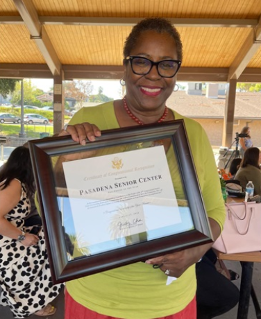 Akila Gibbs Pasadena Senior Center Executive Director holding Non Profit of the Year plaque